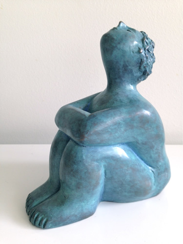 Sculpture of a nude seated female entitled 